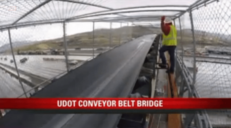Conveyor belt bridge constructed to move wet concrete to point of the mountain project